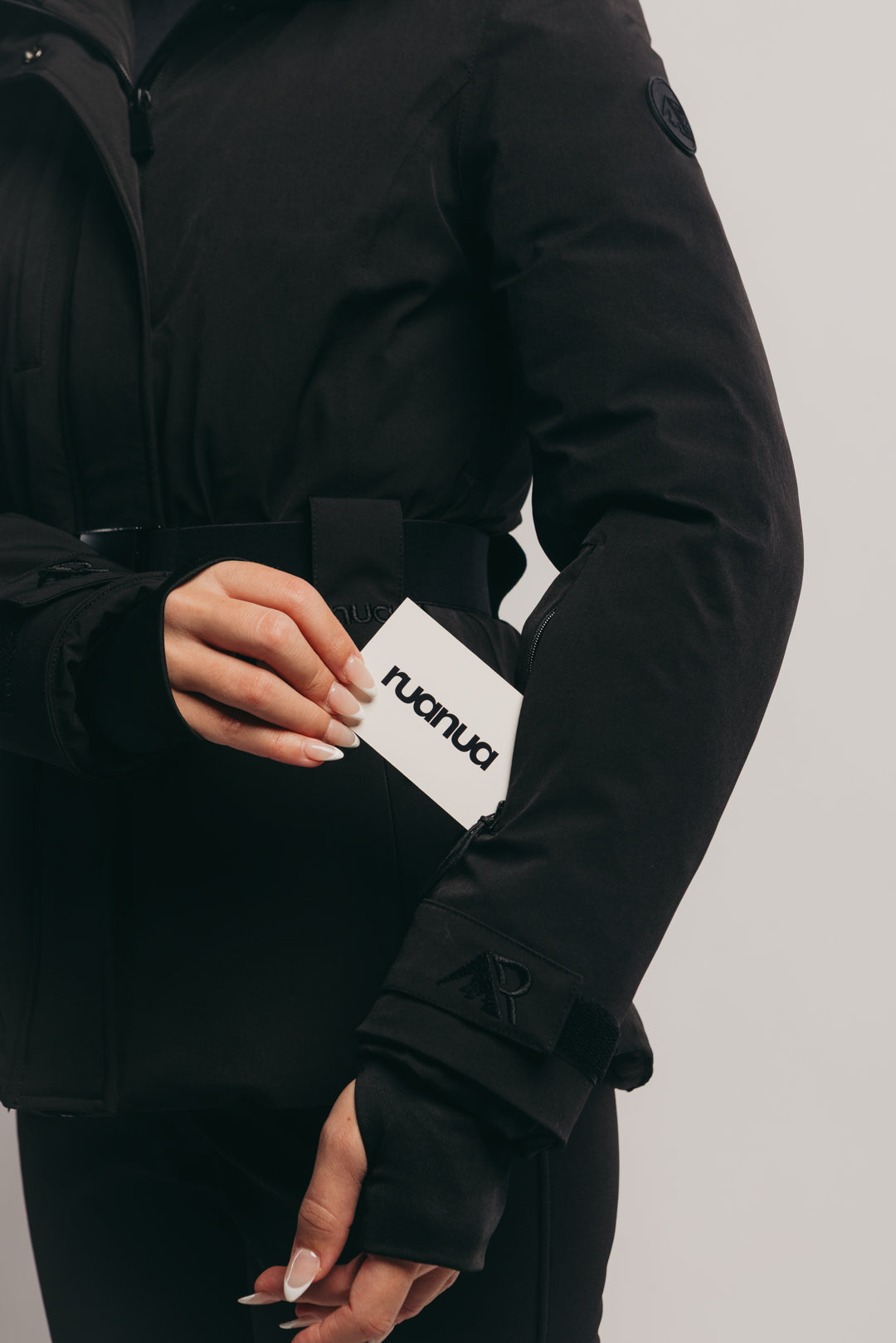 Black ski jacket with a visible brand logo on the sleeve against a neutral background